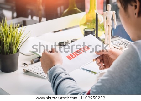hands of Businessman holding Rejection Letter on desktop at home office . selective focus Royalty-Free Stock Photo #1109950259