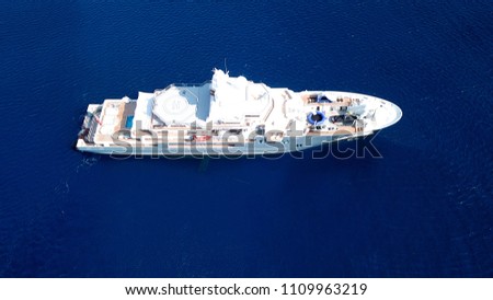 Aerial drone bird's eye view photo of luxury yacht with wooden deck docked in ocean deep blue waters