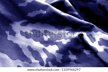 Military uniform pattern with blur effect in blue tone. Abstract background and texture.
