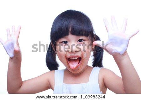 lovely asain kid eating ice cream indoor on white background