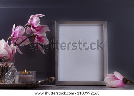 Gray room interior decor with magnolia flowers and poster mock up with copy space