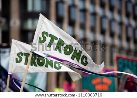 Banners with the word strong waing at a political protest march