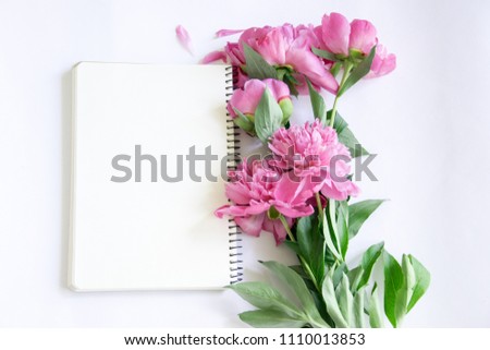 Mockup notebook with a clean sheet of pink peonies