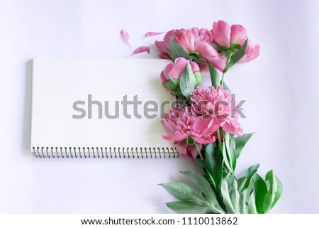 Mockup notebook with a clean sheet of pink peonies
