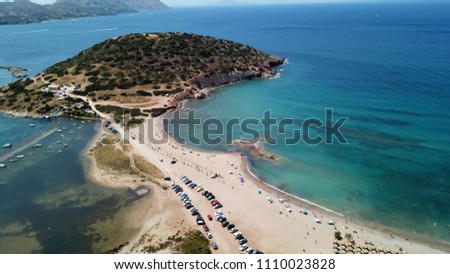 Aerial drone bird's eye view of iconic beach and small islet of Agios Nikolaos, Anavysos, Athens Riviera, Attica, Greece