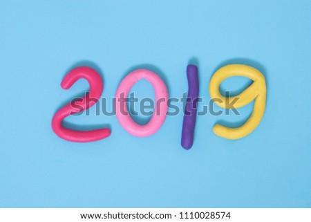 play dough in 2019 number as new year on blue paper background 