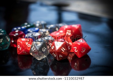 A set of colorful RPG dice on a black table