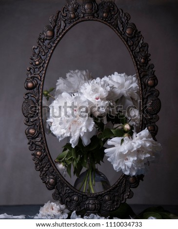old picture frame and white peonies
