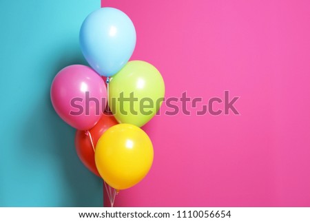 Bright air balloons for birthday party on color background