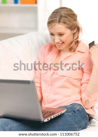 picture of happy woman with laptop computer and credit card..