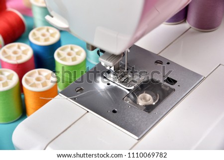 Dressmaker and designer desk, Close up foot of sewing machine and handcraft accessories.