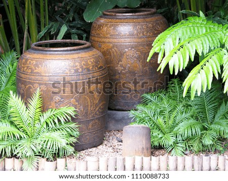 Decorated jar in the green garden