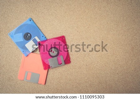 Floppy disk on a wood board.