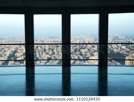 Large windows overlooking the city. Tel Aviv, Israel, sunset. City landscape. View from the skyscraper Royalty-Free Stock Photo #1110128450