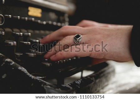 Woman hands writing with an old typewriter