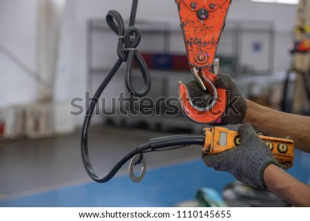 Engineers are inspecting hooks for lifting safety crane steel In the factory auto parts license Crane Operation Royalty-Free Stock Photo #1110145655