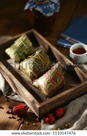 Chinese dragon boat festival rice dumplings and wine on wooden plate