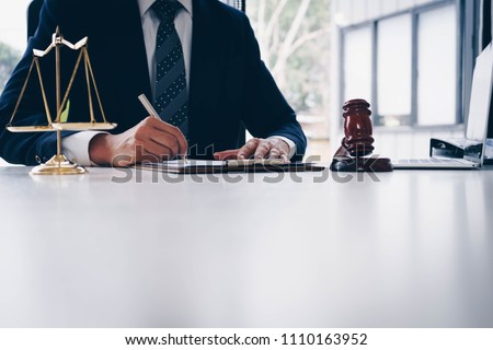Judge gavel with scales of justice. Male lawyers working at the law firms. Legal law, lawyer, advice and justice concept. Royalty-Free Stock Photo #1110163952