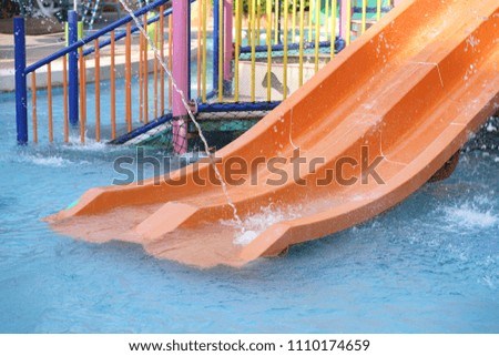 slider ride in swimming pool at water park.