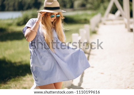 Woman happy in blue dress the beach