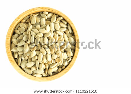 sunflower seeds in wooden bowl on white background