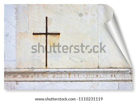 Iron Christian cross snuggled against a white stone on a italian facade church - curl and shadow design concept image with copy space