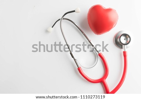 red heart and a stethoscope isolated on white background