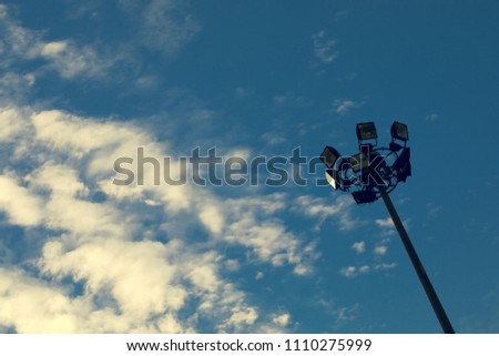 Sunset with the light pole, and blue sky, with cloud of background.