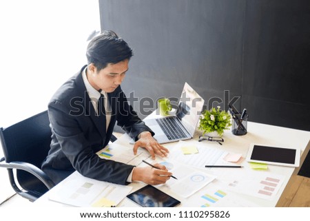 Asian businessman on workplace in office.