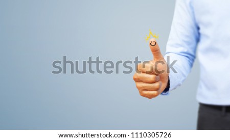 Hand of client show a excellent services rating by thumb with smiley face and crown. Service rating, satisfaction, customer experience concept Royalty-Free Stock Photo #1110305726