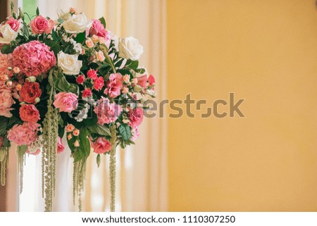 Table setting at a luxury wedding reception. Wedding decorations with flowers. Newlyweds party decor in restaurant reception.  Place for text.