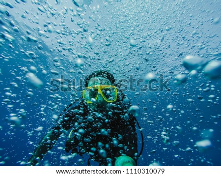 
Young tourist diving in the Gili island, Indonesia, many meters deep, discovering the wild life of the seabed. Lifestyle and travel concept.