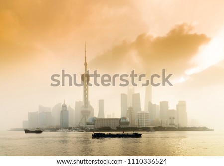 Shanghai Financial Center and modern skyscraper city in misty gold lighting sunrise behind pollution haze, view from the bund in Shanghai, China. vintage picture style 