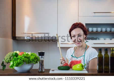Young girl in the kitchen, smile on the face, cooking lunch, various vegetables in preparation, lettuce, broccoli, kitchen, girl in the kitchen, cassia vegetables