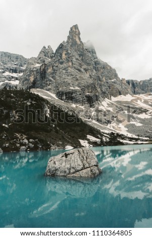 The mountain lake Lago di Sorapiss in Dolomite Alps. Italy, with amazing turquoise color of water.