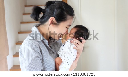 Close up
Portrait of happy Sleeping baby hugging with cheerful young smiling mother. Scene of pure love and happiness. Family, motherhood and lifestyle concept.
