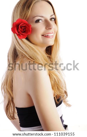 Beautiful young woman with red rose in her long blond hair, smiling, isolated on white