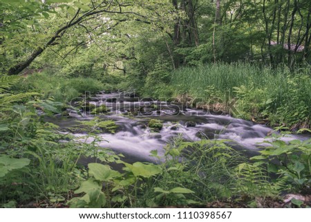 Long exposure river/stream landscape photo of the natural scenery of the Hoshino area of Karuizawa, Japan.