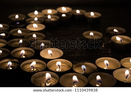 Symbols of Islam. Candle lights on black background. Abstract isolated photo.