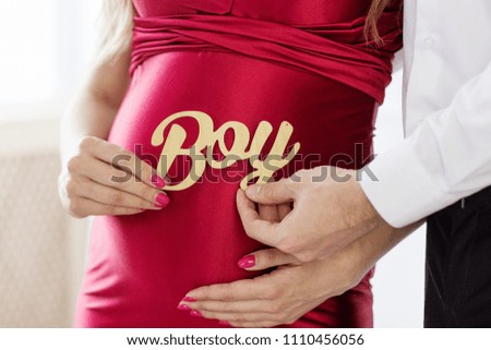 Pregnant belly and the sign "boy"