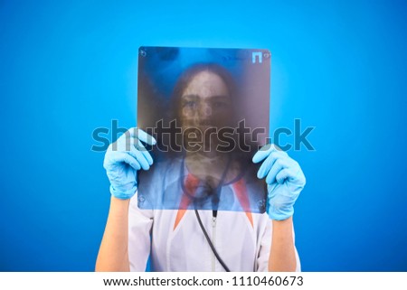 girl doctor looks at x-ray picture
