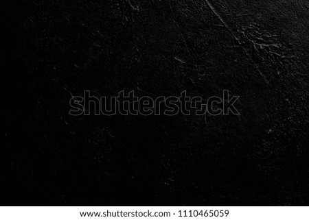 abstract black textured dust background. distressed dark scratched stucco design. free space concept