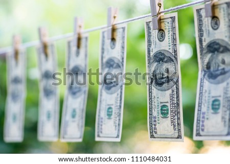 Money Laundering. Money Laundering US dollars hung out to dry. 100 dollar bills hanging on clotheslines Royalty-Free Stock Photo #1110484031