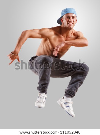 young man in a blue cap dancing hip hop