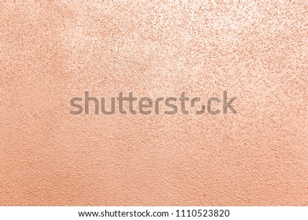 cement or concrete wall painted with orange pearl color texture and background 