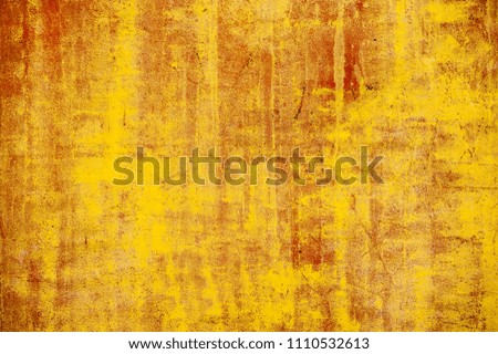 The texture of old industrial red and yellow metal sheets on the wall with scratch, streak and crack looks like background 