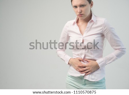 Young woman suffering from abdominal pain