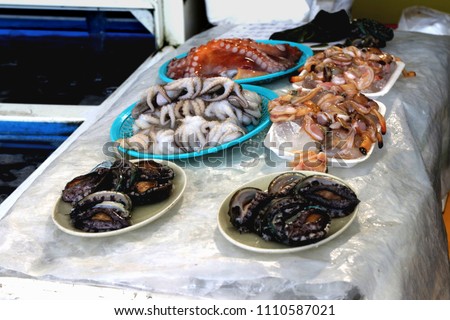 

Fresh seafood such as abalones and octopus with price tag on display at famous Dongmun Traditional Market in Jeju Island,South Korea. Royalty-Free Stock Photo #1110587021
