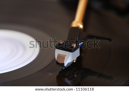 Details of a Vinyl player with a record spinning round.