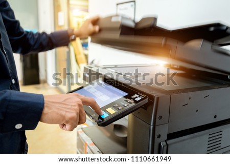 Bussiness man Hand press button on panel of printer, printer scanner laser office copy machine supplies start concept. Royalty-Free Stock Photo #1110661949
